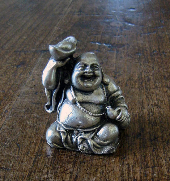Smiling buddha holding an ingot